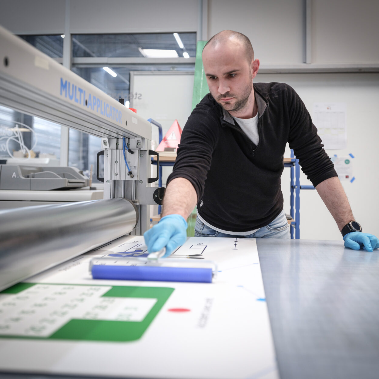 Homme utilisant machine industrielle pour découper matériaux